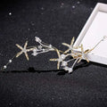 Delicate gold-toned starfish pearl hair accessory adorned with sparkling crystals and soft white pearls