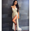 A silver strap sequin dress with a gold v neck, high slit, and delicate lace overlay for elegant occasions