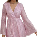 A shimmering pink sequined slimming senior party dress with sequin waist slimming detail and long bell sleeves