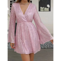 A shimmering pink sequined mini dress with bell sleeves and a deep v-neckline for slimming senior party wear