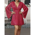 A vibrant fuchsia sequin waist slimming senior party dress with long bell sleeves and a deep v-neckline