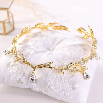 Golden crown headband wedding headdress adorned with clear crystals and teardrop pendants for elegant occasions