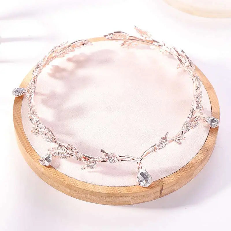 Golden crown headband wedding headdress adorned with clear crystals and teardrop pendants for elegant occasions
