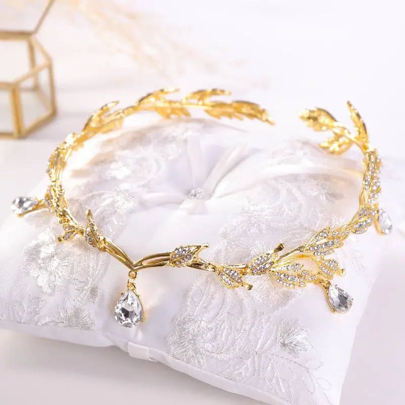 A delicate golden crown headband wedding featuring clear crystals and teardrop pendants for elegant headband wedding headdress