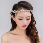 Golden crown headband wedding headdress with silver leaf pattern and dangling crystal teardrops for special occasions