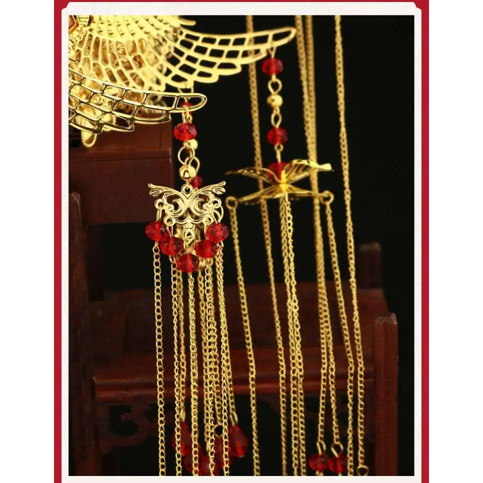 Golden ornate wedding chinese xiuhe headdress adorned with red gemstones and dangling chains with ear clip