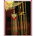 Golden ornate wedding chinese xiuhe headdress featuring a hairpin with red beads and intricate winged designs