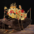 Golden ornate wedding chinese xiuhe headdress with intricate floral filigree red gemstones and dangling tassels with ear clip