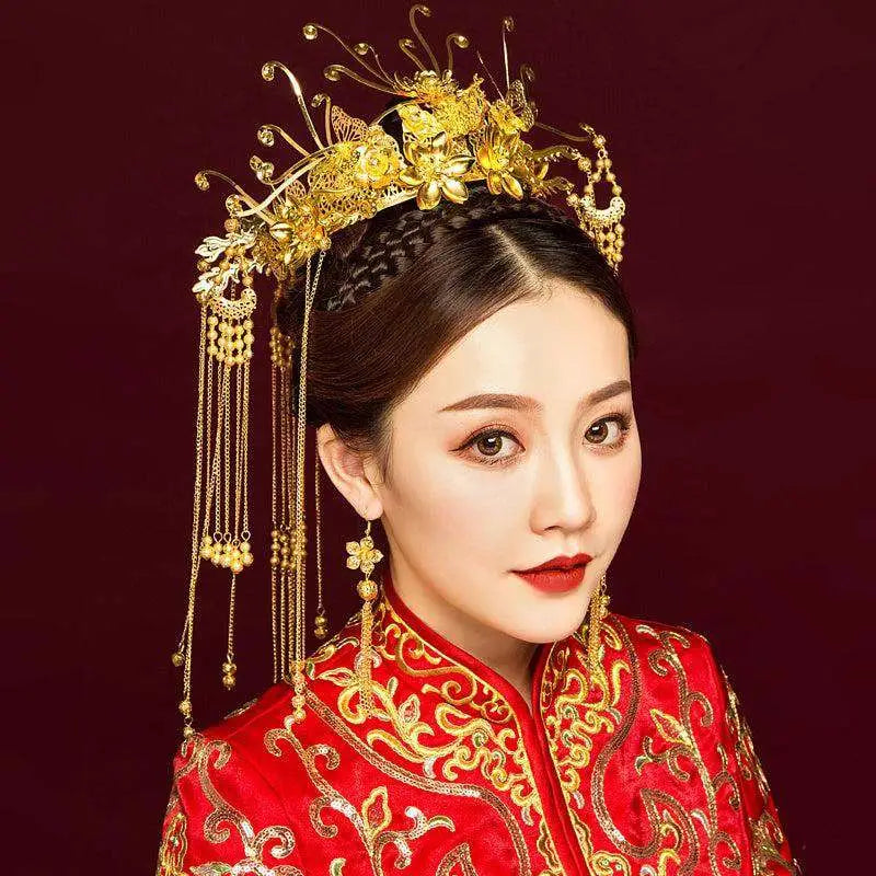 Golden ornate wedding chinese xiuhe headdress with intricate floral and bird motifs and beaded dangling chains