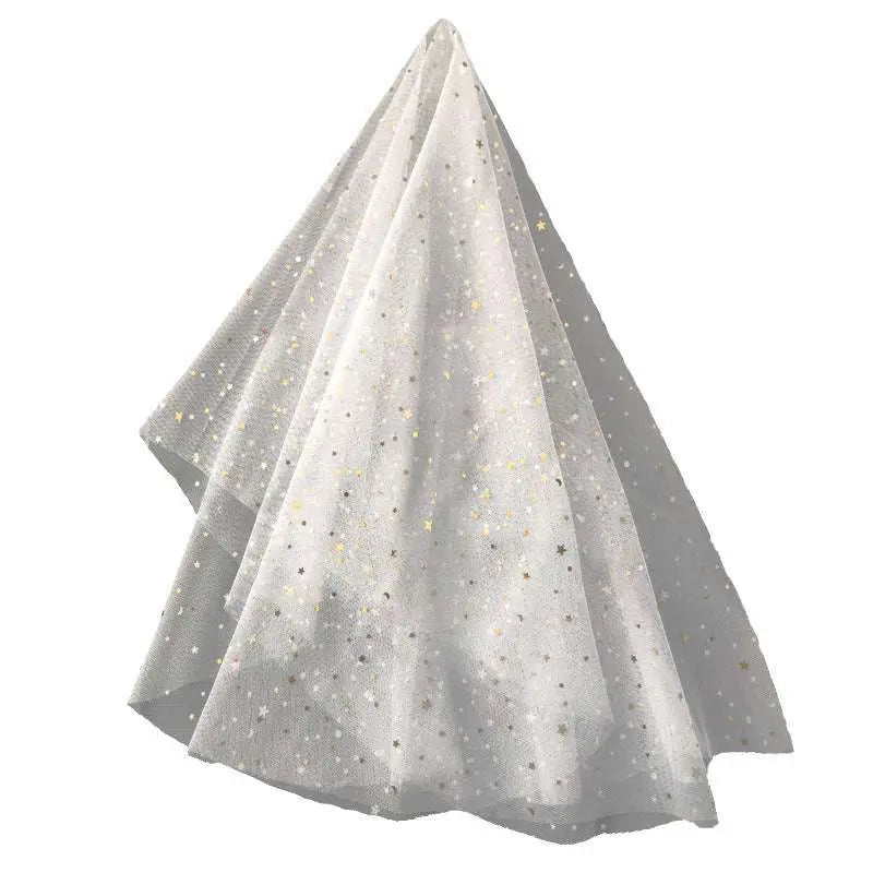 A golden shiny big veil in white sheer fabric with scattered silver and gold star-shaped embellishments