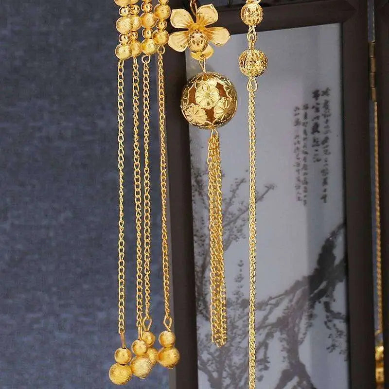 Golden ornate tassel suit wedding cheongsam hair accessory with intricate floral designs and dangling chains and beads