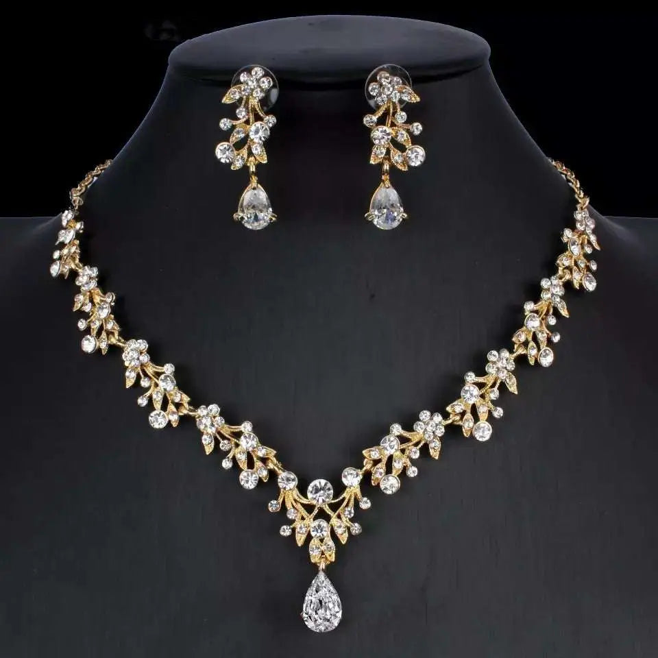 Gold-toned golden zircon jewelry set with intricate leaf and crystal designs featuring a bridal floral necklace and earrings