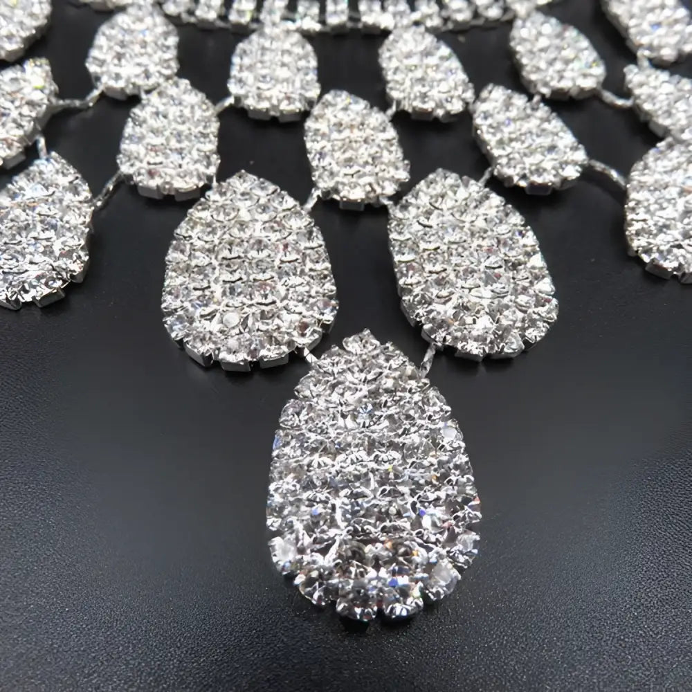 A sparkling silver teardrop rhinestone charm with clear crystals in a gorgeous diamond necklace set wedding bride accessory