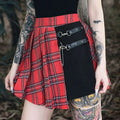 Gothic pleated short skirt in red and black plaid with a black panel featuring leather straps and metal hardware
