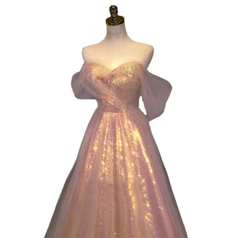 A shimmering blush pink off-the-shoulder party banquet mermaid dress with sequined bodice and gradient mesh slimming design