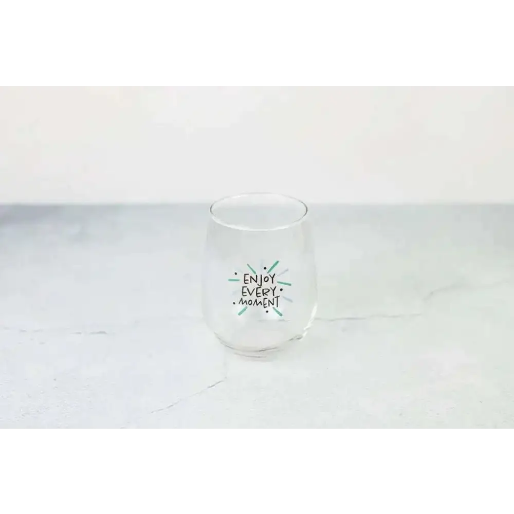 Clear stemless wine glass with enjoy every moment printed in black and green in grapefruit body scrub spa gift basket