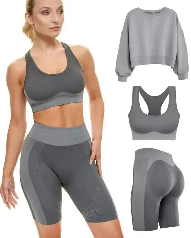 gray athletic two-piece workout set featuring a cropped sweatshirt, sports bra, and high waist shorts with mesh panels designed for performance-enhancing fitness attire.