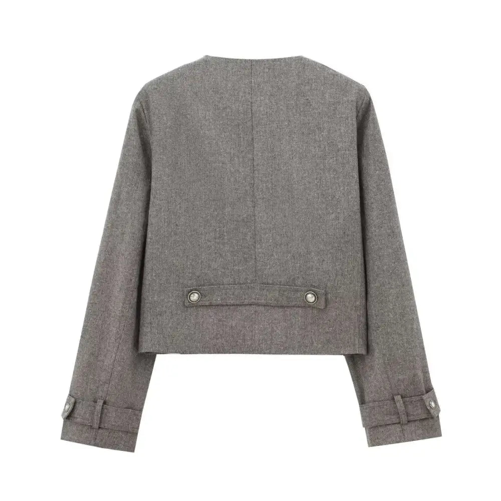Gray double breasted coat with silver buttons and textured fabric paired with blended coat width pleated skirt