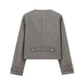Gray textured wool double breasted coat with silver buttons and adjustable cuffs paired with blended coat width pleated skirt