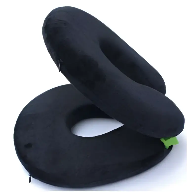 Gray foldable travel pillow with plush cushioned texture and circular design featuring green fabric accents
