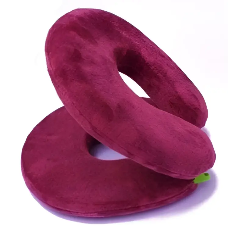 Maroon plush foldable travel pillow with soft velvety texture and circular design, ideal for comfortable travel