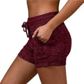 Maroon heathered women shorts with drawstring waistband and side pockets made of stretch sports fabric