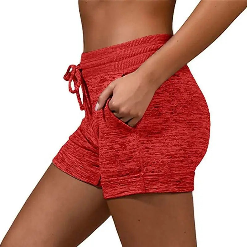 Red heathered athletic shorts with drawstring waistband and side pockets made from stretch sports fabric for women