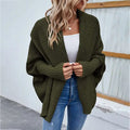 Olive green solid color cardigan with ribbed cuffs and relaxed open-front design as a loose knitted sweater