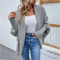 Gray loose knitted sweater solid color cardigan with ribbed cuffs and relaxed open-front design in knitted fabric