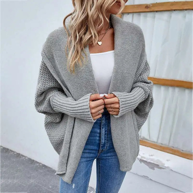 Gray loose knitted sweater with solid color cardigan design featuring ribbed cuffs and an open front style