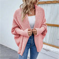 Soft pink solid color cardigan with ribbed cuffs featuring a loose knitted sweater textured weave design