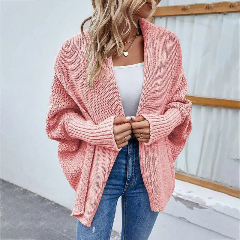 Soft pink solid color cardigan with ribbed cuffs featuring a loose knitted sweater textured weave design