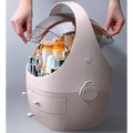 A sleek blush-pink plastic makeup organizer with waterproof dust proof transparent dome lid and two drawers