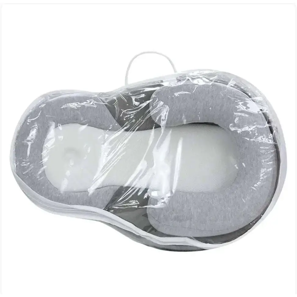 Gray and white memory foam baby anti-spit up pillow wrapped in clear plastic featuring pure cotton fabric cover