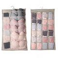 Beige fabric lingerie hanging storage bag with multiple compartments holding bras and panties in soft pastel shades