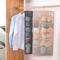 Beige and gray mesh hanging storage bag with multiple compartments for organizing bras and socks on a rod