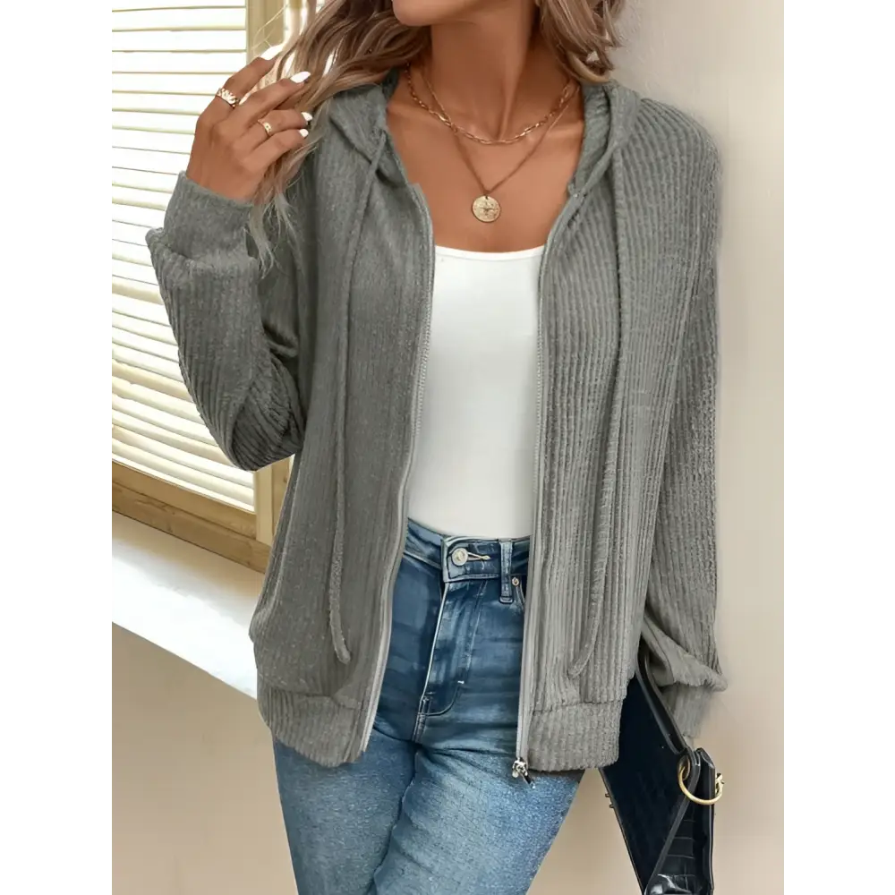 Gray ribbed knit solid color hooded zipper hoodie made of ribbed fabric with a front zip closure and hood