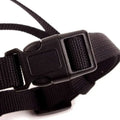 Black nylon strap with durable plastic buckle on the back side of gray silicone dog muzzle for vet visits safety