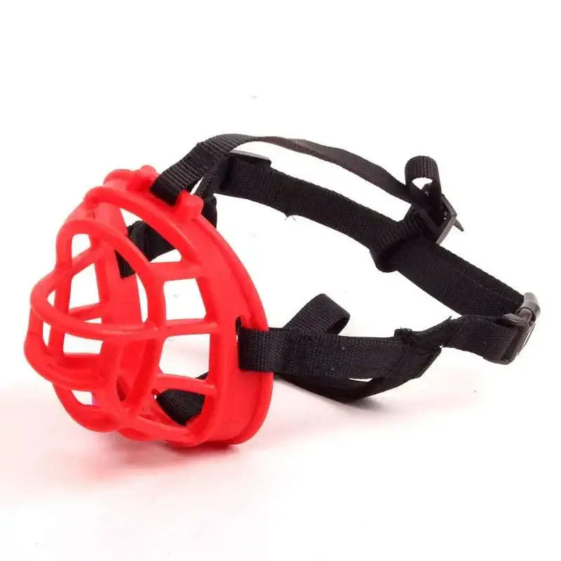 Red plastic mesh dog muzzle with black adjustable straps and buckles for gray silicone dog vet visits