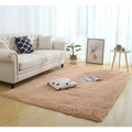 A plush peach-colored shaggy area rug with soft texture perfect as a silky fluffy carpet for carpet modern home decor