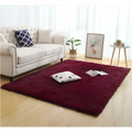 A deep burgundy plush shag rug with silky fluffy carpet texture and slightly raised edges for carpet modern home decor