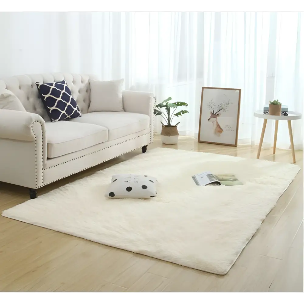 Cream-colored plush faux fur area rug with silky fluffy carpet texture and slightly irregular edges for modern home decor