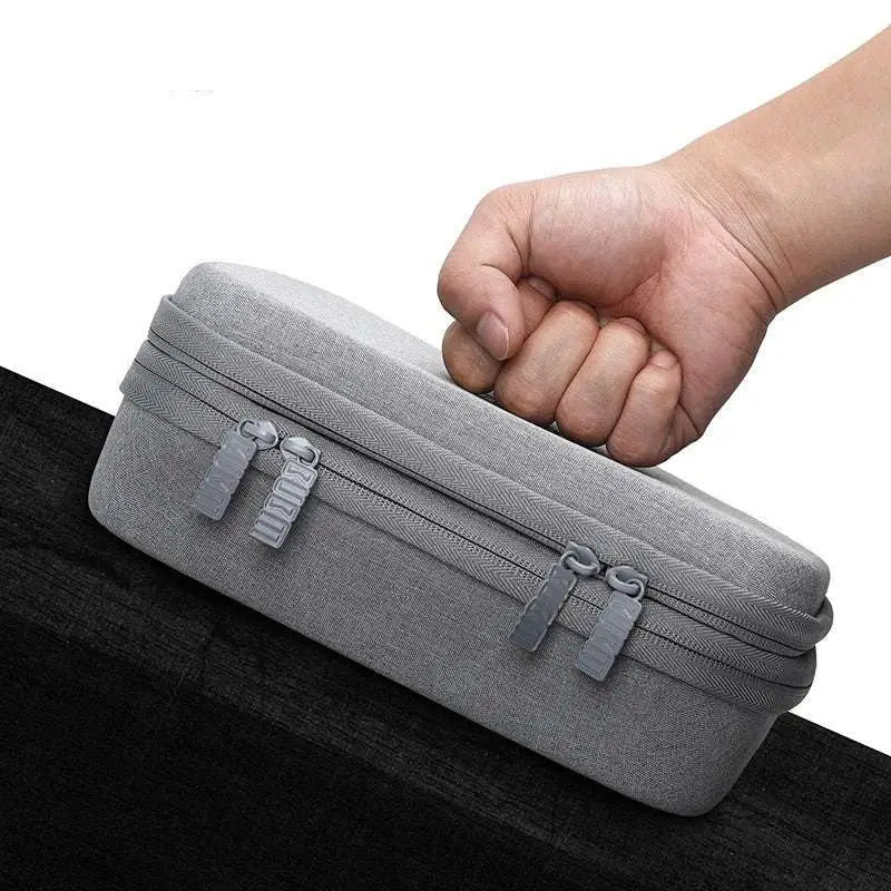 Gray textured fabric digital storage bag travel organizer with dual zippers and matching pull tabs for secure storage
