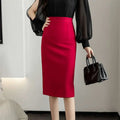A vibrant red line sheath skirt in smooth tailored fabric offering an elegant tight fit for formal occasions