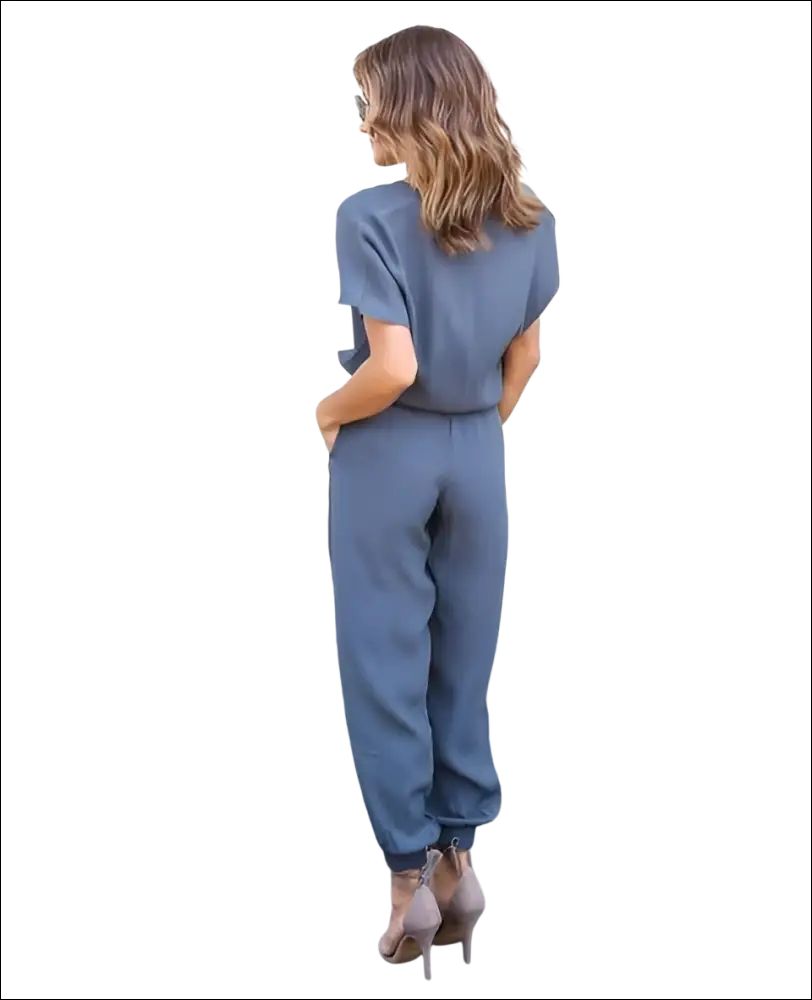 A sleek slate-gray v-neck jumpsuit with short sleeves and tapered pants in a v-neck jumpsuit image