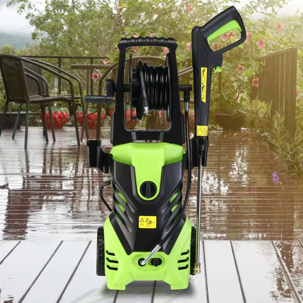 Green and black high pressure cleaner with coiled hose mounted for efficient cleaning and durability