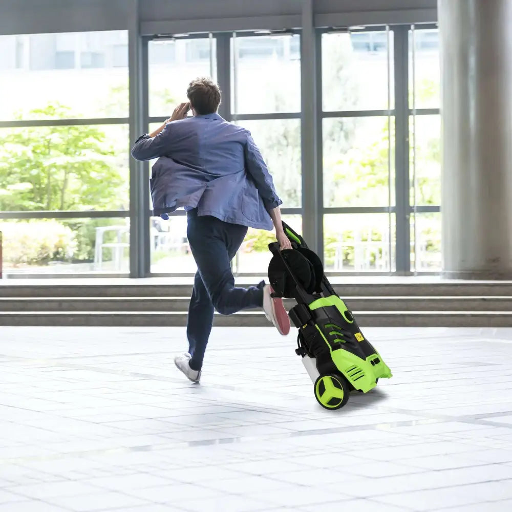 Green and black high pressure cleaner with coiled hose and spray nozzle designed for efficient cleaning tasks
