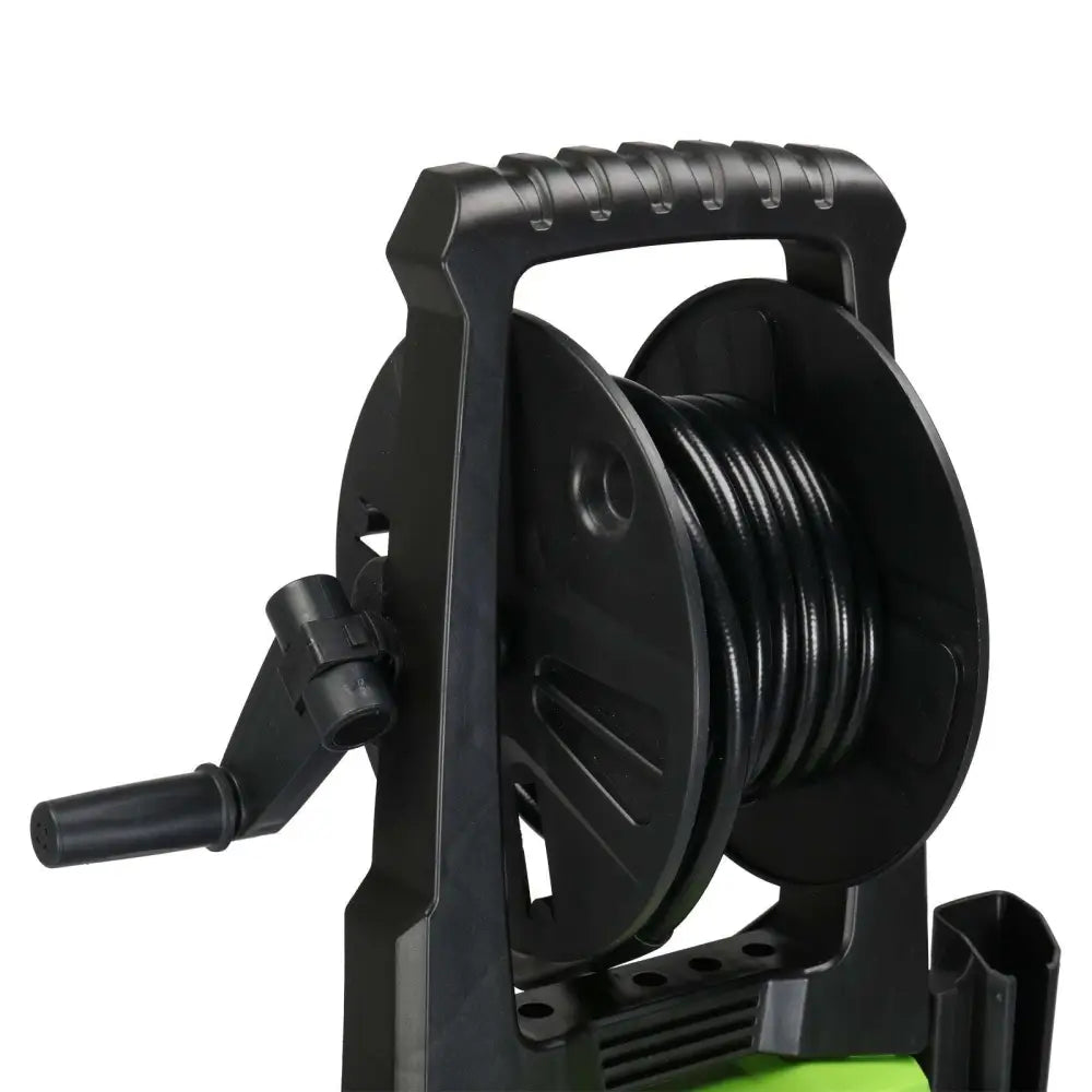 Black plastic garden hose reel with textured handle and crank on green and black high pressure cleaner with coiled hose