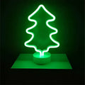 A glowing green christmas tree led neon light with sleek minimalist design creating perfect ambiance on base