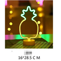 A glowing neon pineapple lamp with yellow body and green top on a base creates perfect ambiance led neon lights
